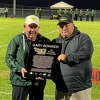 Gary Bowker (left) is presented a plaque by Southwestern AD Brian Hanslow commemorating Bowker's 50 years as a coach for the Piasa Birds during a halftime ceremony in the Sept. 23 football game against Pana in Piasa.