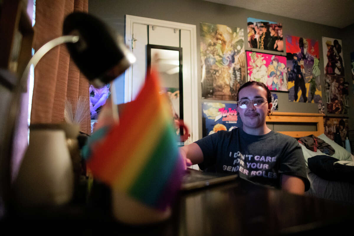 Community college student Keith Harrelson, 20, sits on the space where he studies from his home, Friday, Sept. 30, 2022, in Dickinson. Harrelson who is transgender, decided to switch to online school for his senior year of high school after bad experiences at Dickinson High School.