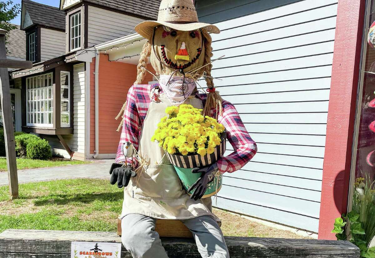 Garden Specialties' "Chrissymum" is dressed like a farmer holding flowers.