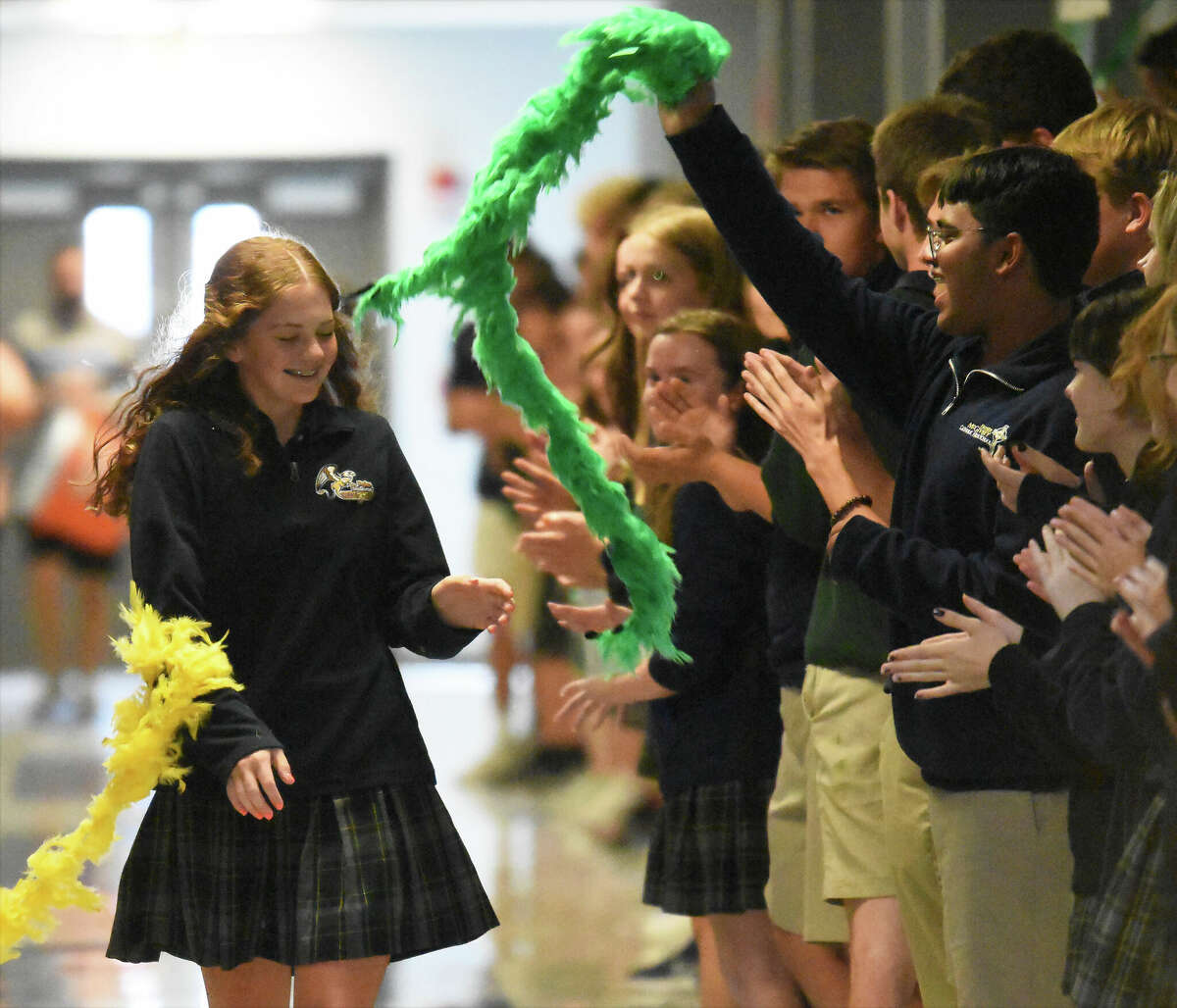 Father McGivney's Sarah Hyten walks down her school's main hallway for a state tournament sendoff on Wednesday in Glen Carbon.