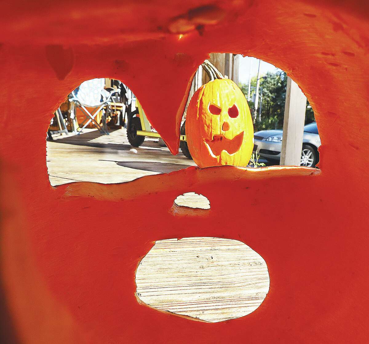 John Badman|The Telegraph Hand-carved pumpkins are turning into jack-o-lanterns all over the area as Halloween, a popular time of year in Alton, gets into full swing with scary decorations in yards everywhere. A view from inside a carved pumpkin in the 2800 block of Brown Street in Alton looks toward another creation on the same porch. The days are counting down to Halloween and its parades, including the large one in Alton at 7 p.m. on Monday, Oct. 31.