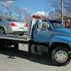 A flatbed tow truck carrying a silver Chevy Malibu is shown in this Getty file photo. 