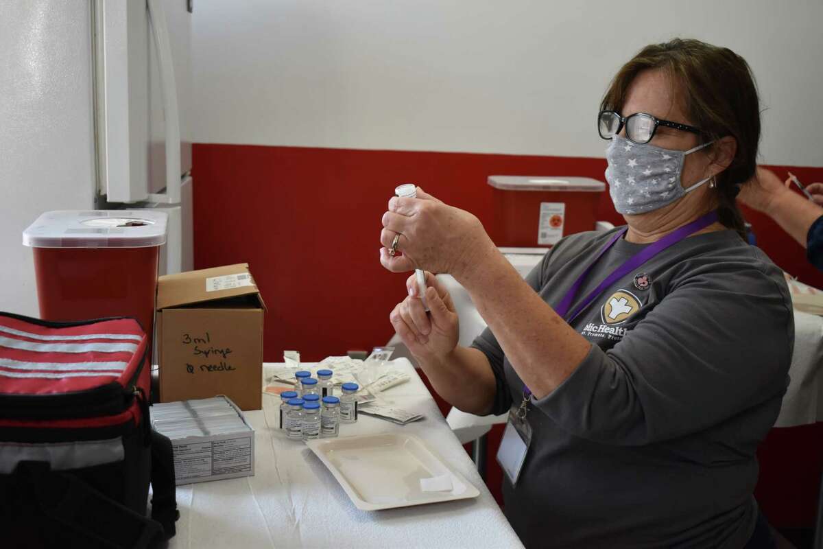 Registered Nurse Leta Malcott prepares booster shots for the Morgan County Health Department's Flu Bowl and COVID-19 booster clinic. The clinic continues Friday from 9 a.m. to 2 p.m. Those interested can get a flu shot or a Moderna or Pfizer COVID-19 vaccine booster.