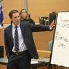 Attorney Chris Mattei points to a white board he had written on during his closing statements in the Alex Jones Sandy Hook defamation damages trial in Superior Court in Waterbury on Thursday, October 6, 2022, Waterbury, Conn. H John Voorhees III - Hearst Connecticut Media.