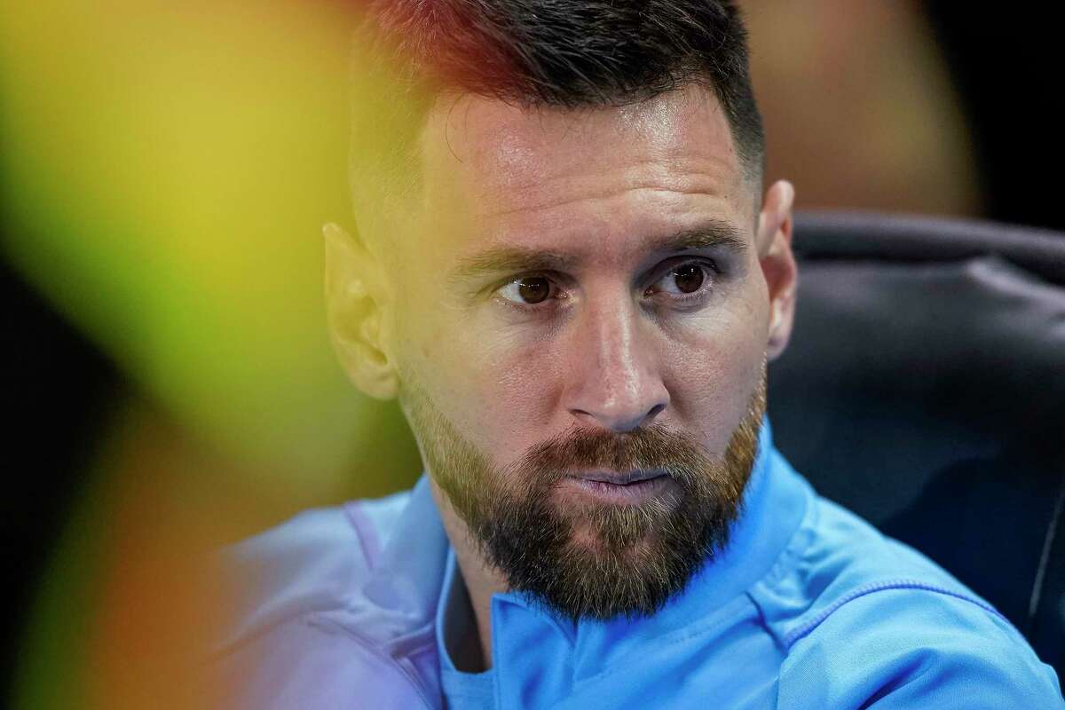 Argentina forward Lionel Messi sits before the team's international friendly soccer match against Jamaica on Tuesday, Sept. 27, 2022, in Harrison, N.J.