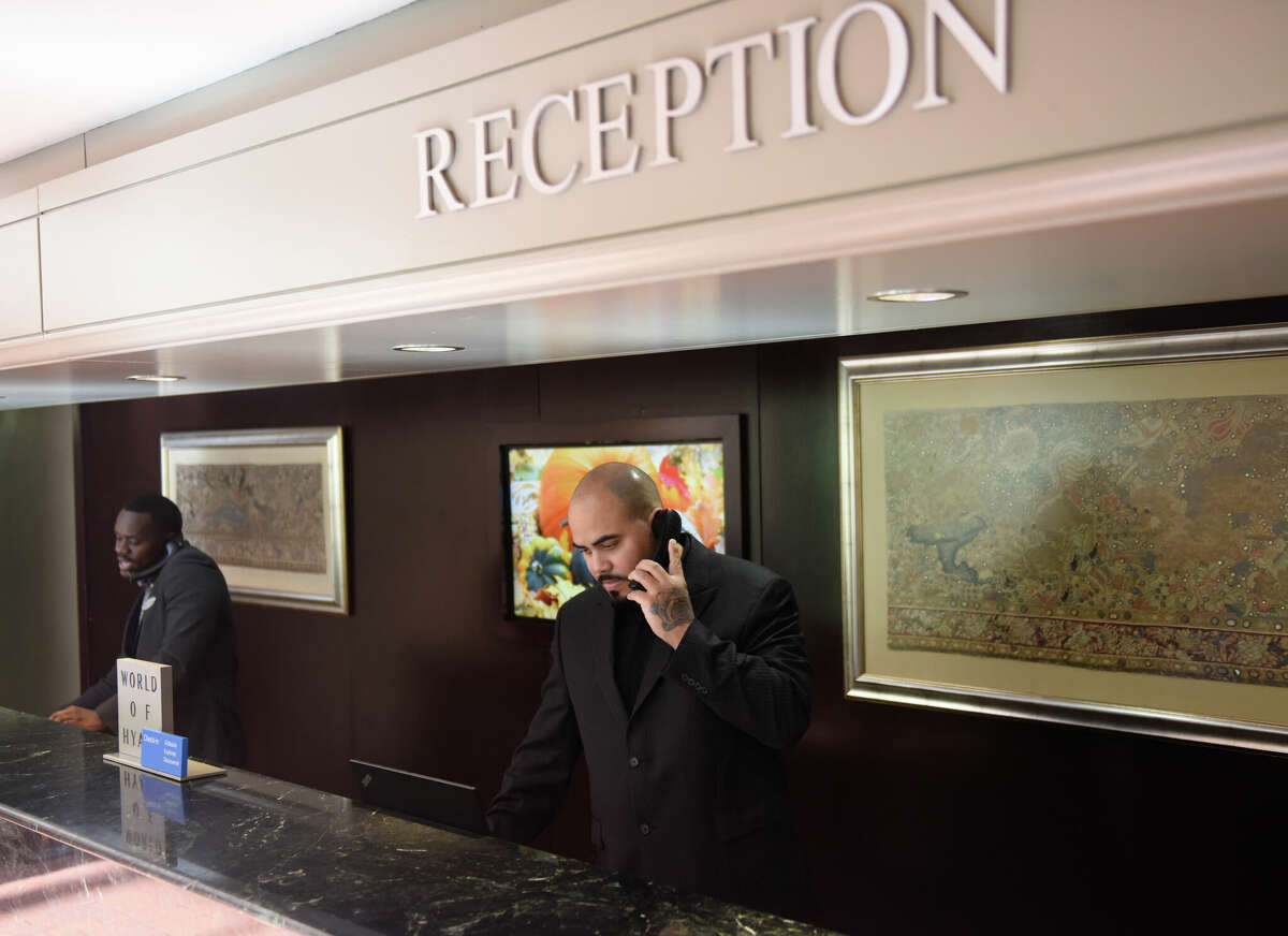 Ferdinand Martinez answers the phone in the reception area at the Hyatt Regency Greenwich in Old Greenwich, Conn. Thursday, Oct. 6, 2022. The Hyatt Regency Greenwich has been sold to an investment fund and is now poised to undergo a multi-million dollar renovation.