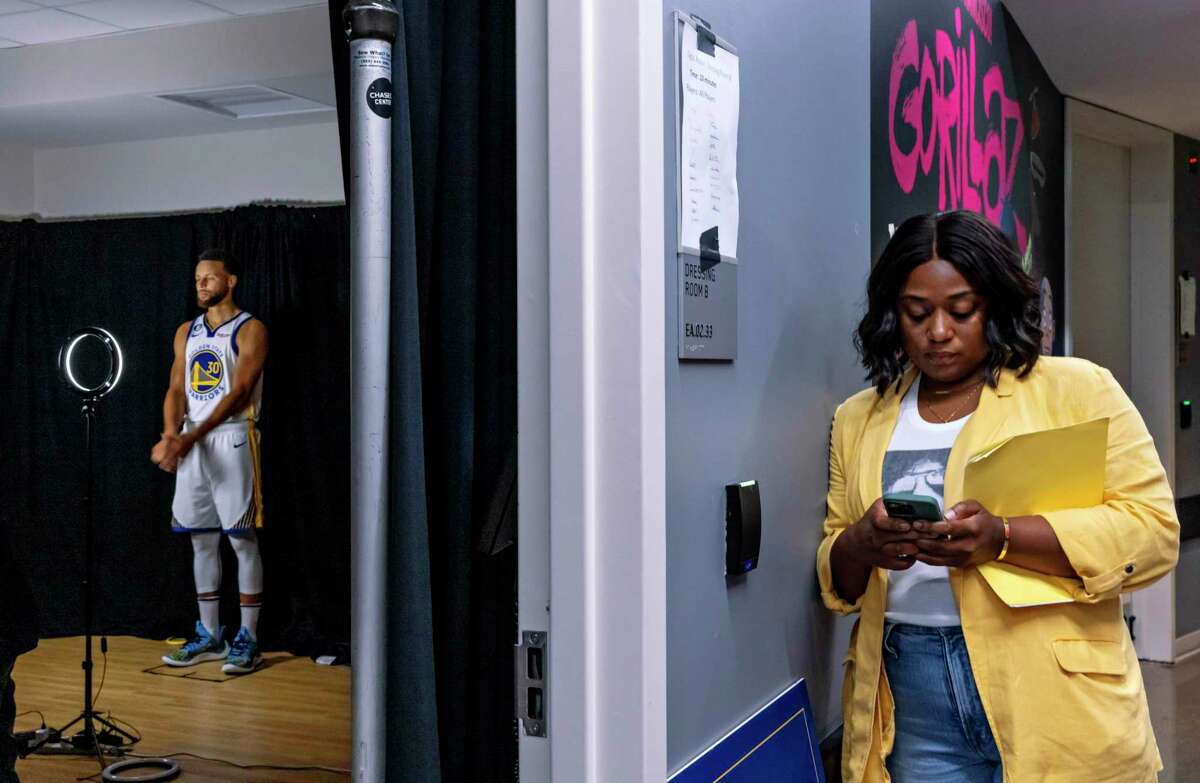 Tiffany Williams, right, waits outside Stephen Curry’s media session during Warriors media day at Chase Center in San Francisco on Sept. 25. Williams is the keeper of Curry’s daily itinerary as the chief operations officer of SC30 Inc.