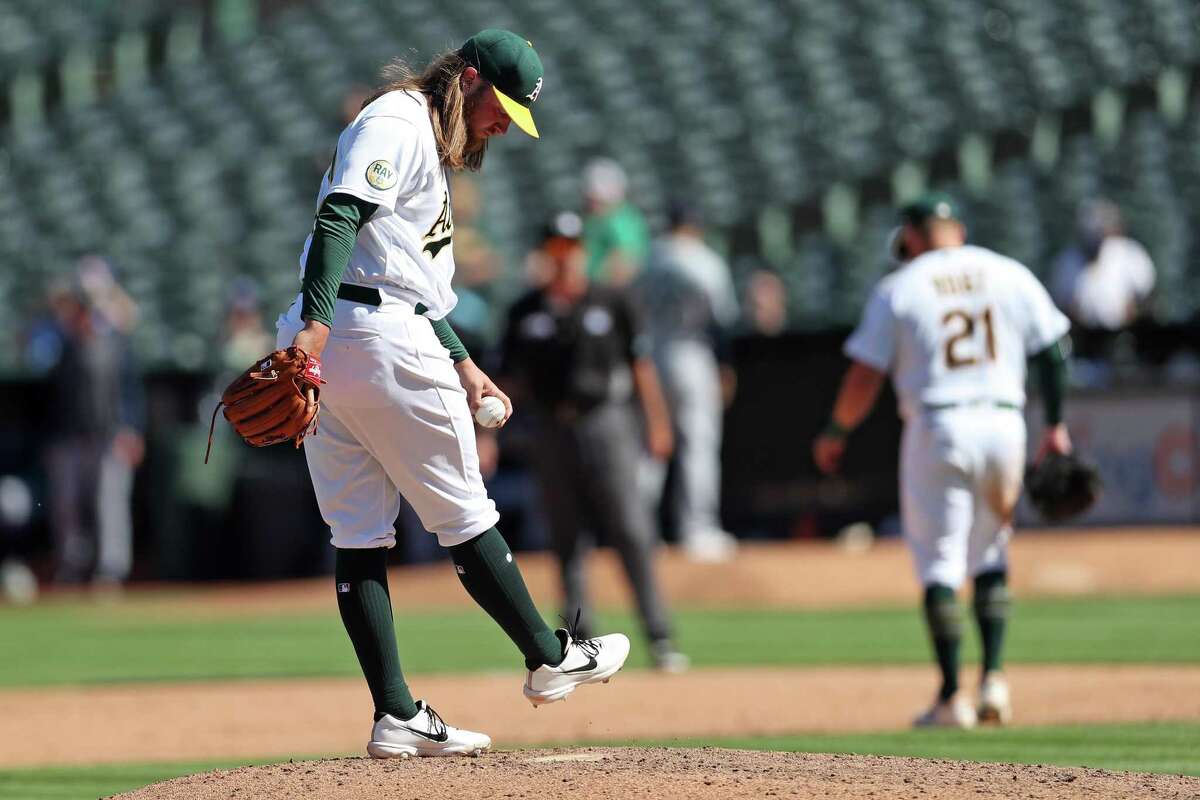 Oakland Athletics’ Kirby Snead kicks the dirt after giving up a 2-run double to Seattle Mariners’ Adam Frazier in 6th inning during MLB game at Oakland Coliseum in Oakland, Calif., on Thursday, September 22, 2022.