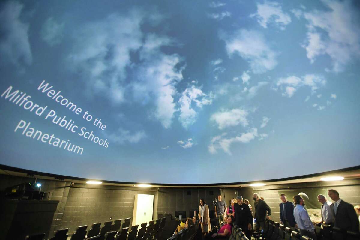 Dignitaries tour the newly updated Milford Public Schools planetarium following a ribbon-cutting ceremony at Foran High School in Milford, Conn. on Thursday, October 6, 2022.