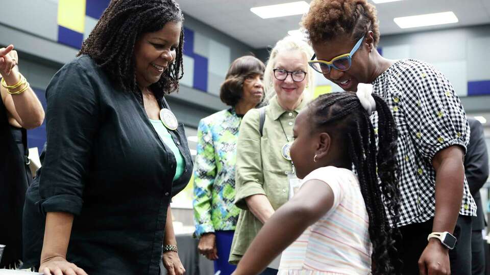 Annette Gordon-Reed, left, visits with first grader Peyton Williams with her mom, Tarsha Hicks, before a dedication ceremony for the elementary school named in Gordon-Reed's honor, Thursday, Oct. 6, 2022. Gordon-Reed won the 2009 Pulitzer Prize in History, and was the first African American student to attend a Conroe ISD school in the mid-'60s.