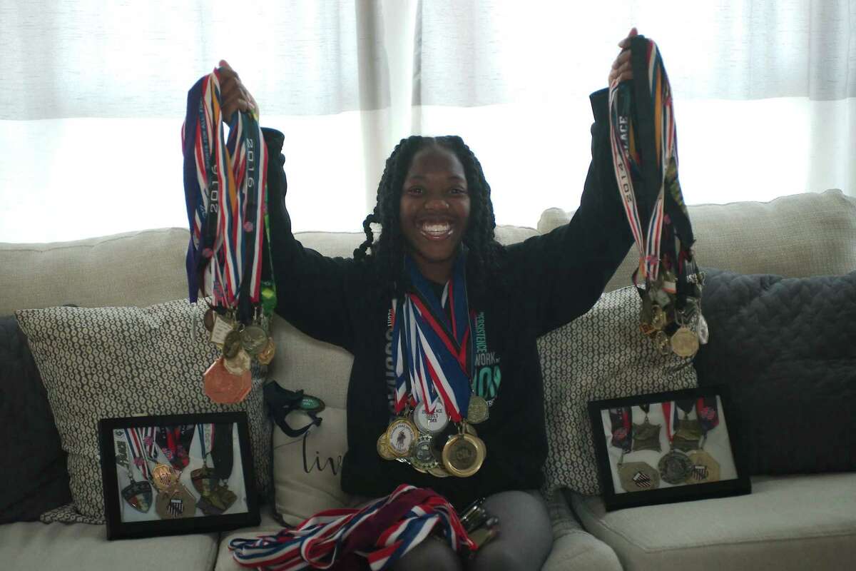Pearland's Maddie Peters displays a lifetime of track and cross country medals at her home.