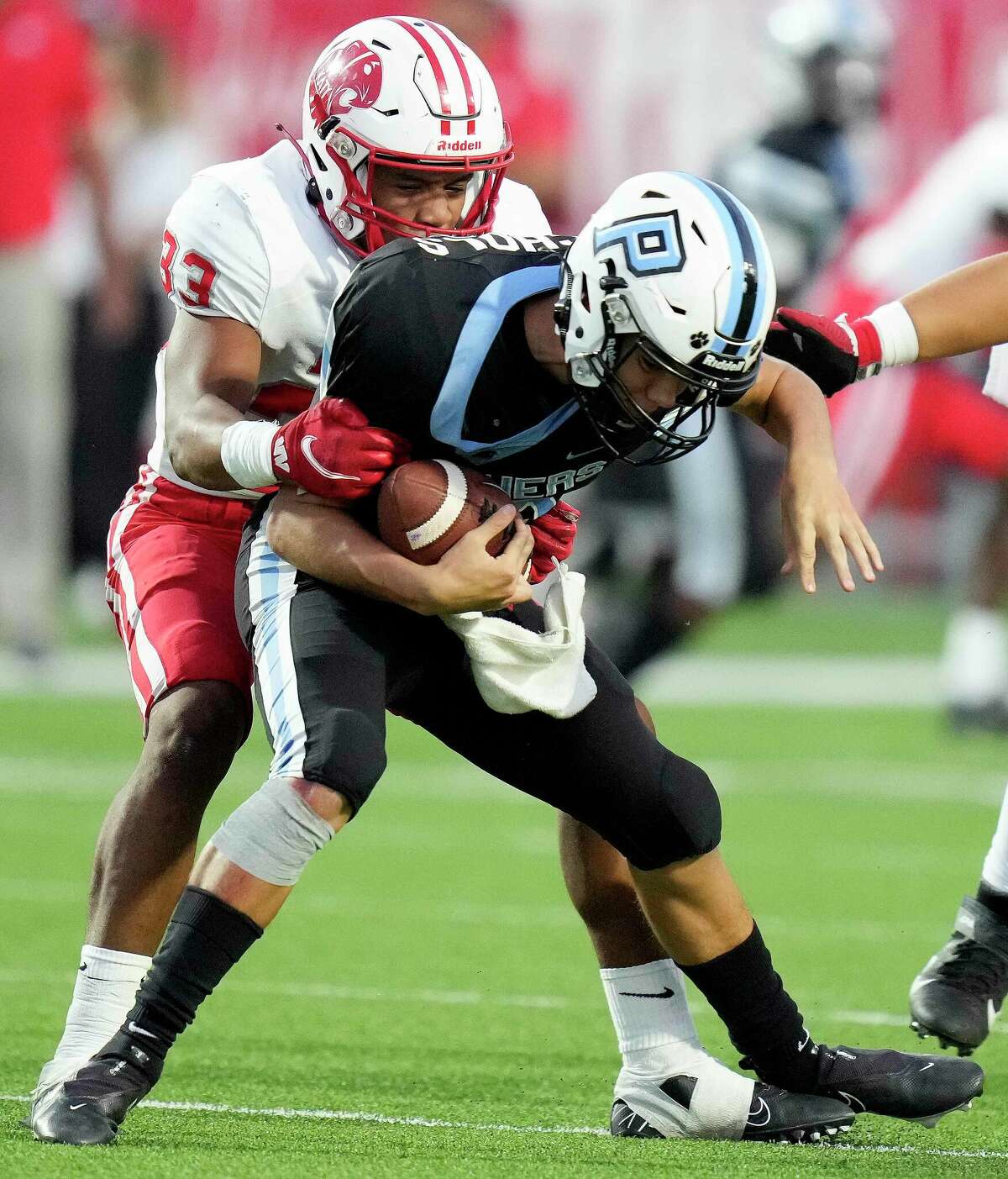 Katy linebacker Damian Neveaux, left, sacks Paetow quarterback Brock Nichols during the first half of a high school football game, Thursday, Oct. 6, 2022, in Katy.