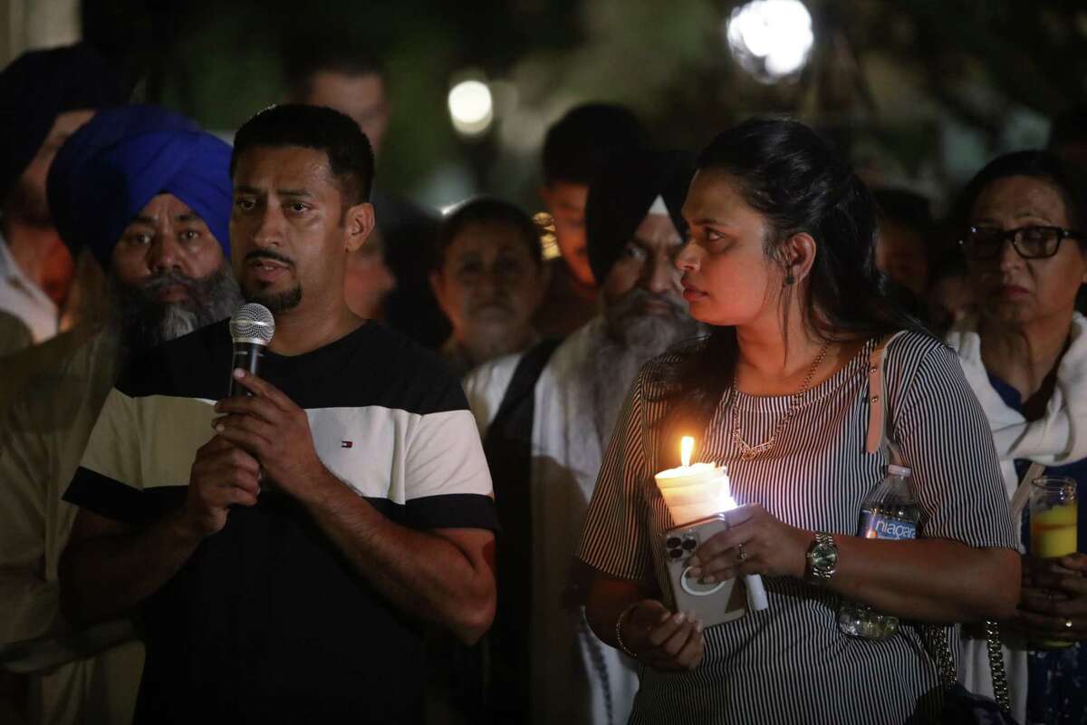 Sikdeep Singh, left, speaks at a candlelight vigil for the Singh family at Bob Hart Square in Merced, Calif., on Thursday, October 6, 2022. Sukdeep Sing is a cousin of the family. And Surjit Kaur is an aunt. Four members of the Singh family were abducted and killed this week.