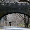 New Haven-- A woman enjoys a mid-morning run through Edgewood Park in New Haven under the Edgewood Avenue overpass . Photo- Peter Casolino/New Haven Register 03/19/12