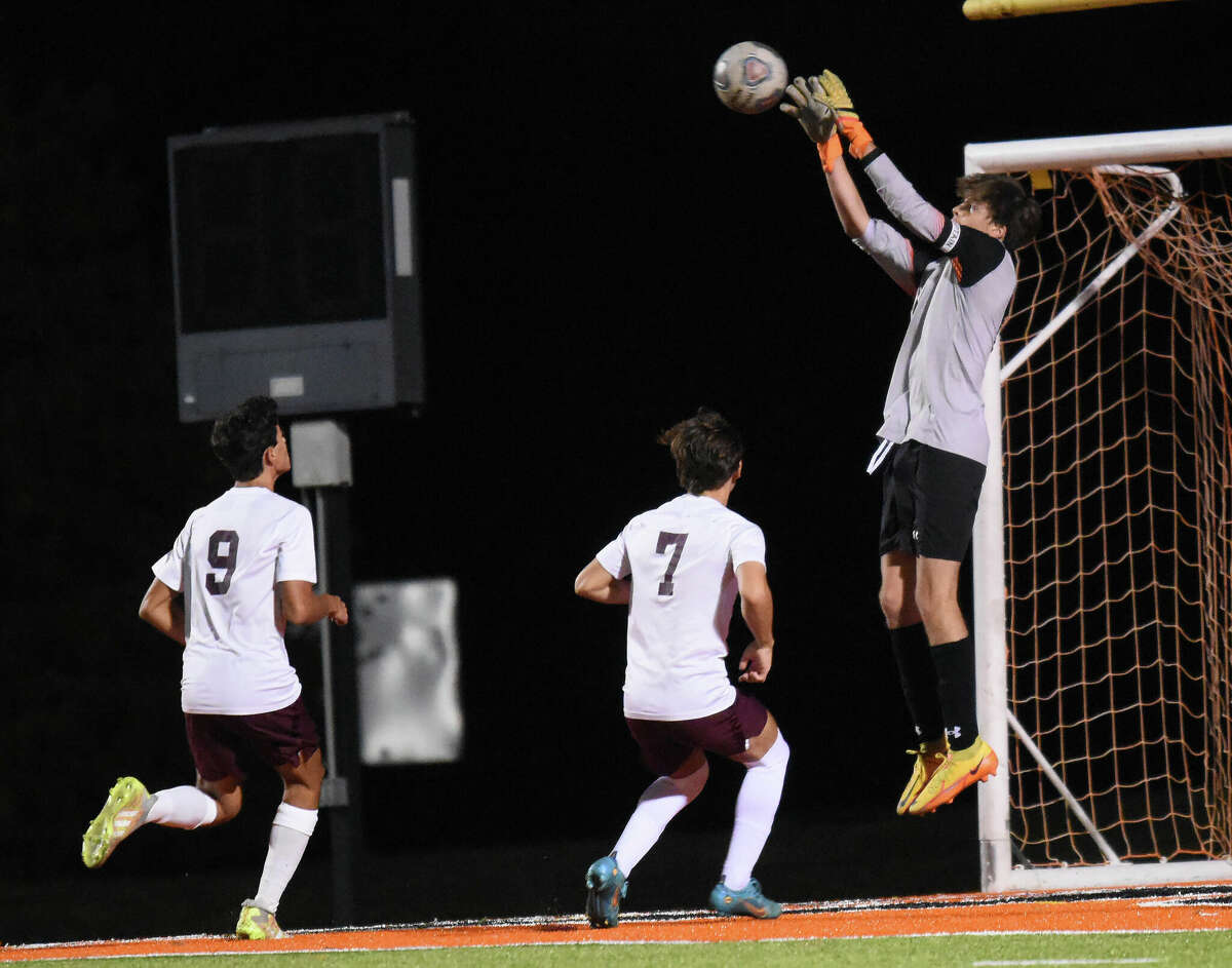 Edwardsville's Zach Chitwood goes high for a save against Belleville West on Thursday inside the District 7 Sports Complex in Edwardsville.