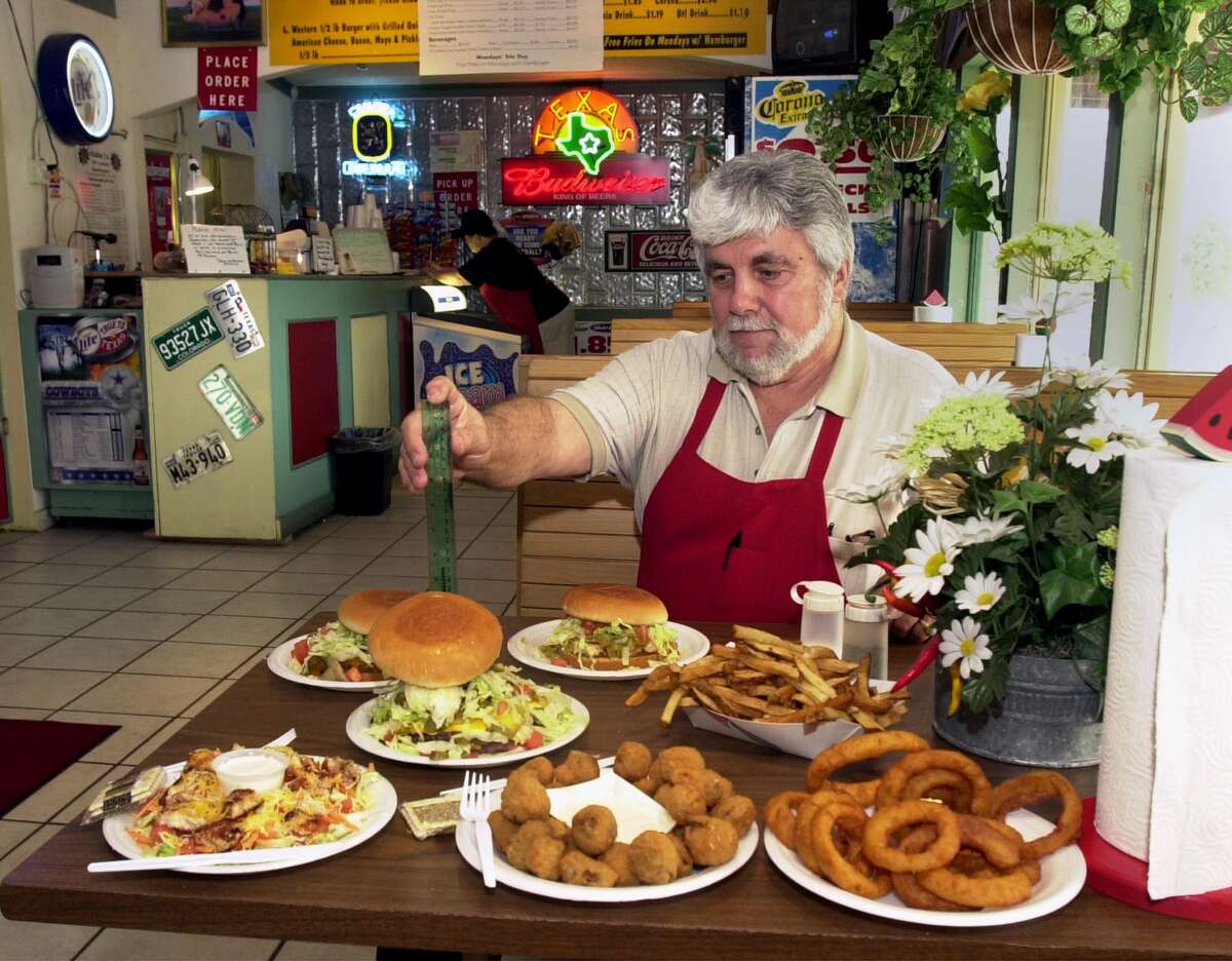 Bob Sfalos measures his 6-inch tall Hungry Texan 1-pound Old Fashion Hamburgers in 2002. Bobby J's owner died in 2009. 