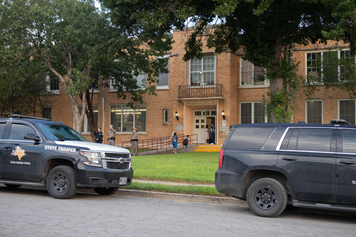 Kids walk past two law enforcement on their way into school as students go back to school months after deadly US shooting in Uvalde, Texas, United States on September 06, 2022. 