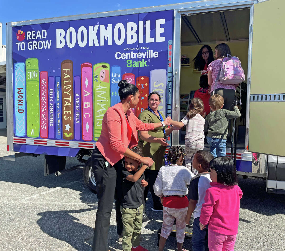 Preschool and kindergarten students at the Thomas W. Mahan Elementary School in Norwich enjoy Read to Grow's bookmobile.