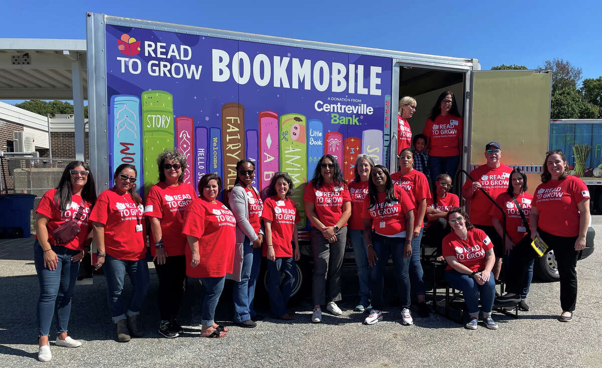 The Read to Grow staff celebrates the launch of the bookmobile at at the Thomas W. Mahan Elementary School in Norwich.