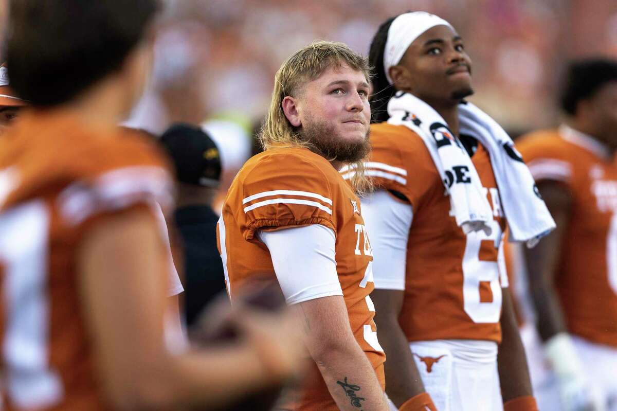 Texas quarterback Quinn Ewers (3) stands on the sideline during the first half of the team's NCAA college football game against West Virginia on Saturday, Oct. 1, 2022, in Austin, Texas. (AP Photo/Stephen Spillman)