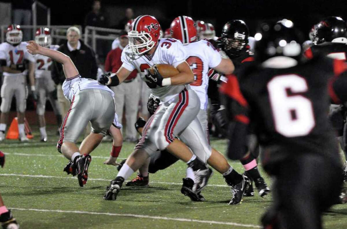 New Canaan's Conor Goodwin carries the ball during the football game against Fairfield Warde at Warde on Friday, Oct. 8, 2010.