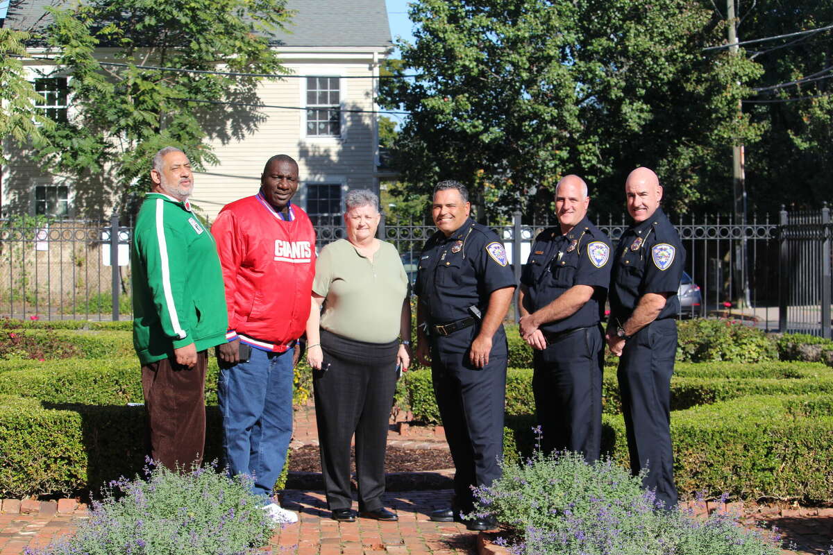 From left, St. Vincent de Paul Middletown employee Paul Prevost and outreach worker James Thomas join Executive Director Maryellen Shuckerow, Police Chief Erik Costa, Capt. David Godwin and Deputy Chief Richard Davis at the Ferry and Main streets garden Thursday off Main Street.