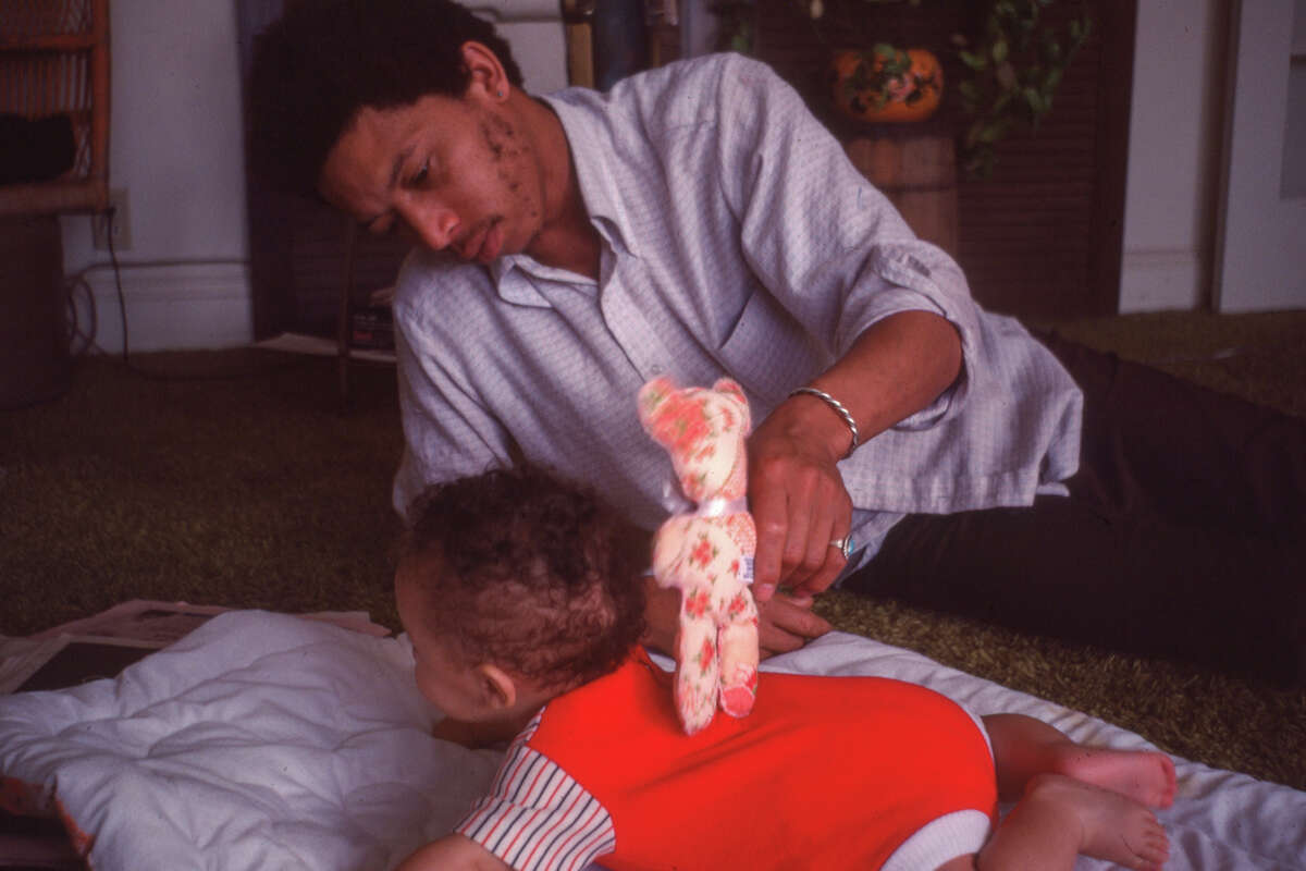 Raymond Cooper playing with his son Ahmed Cooper.