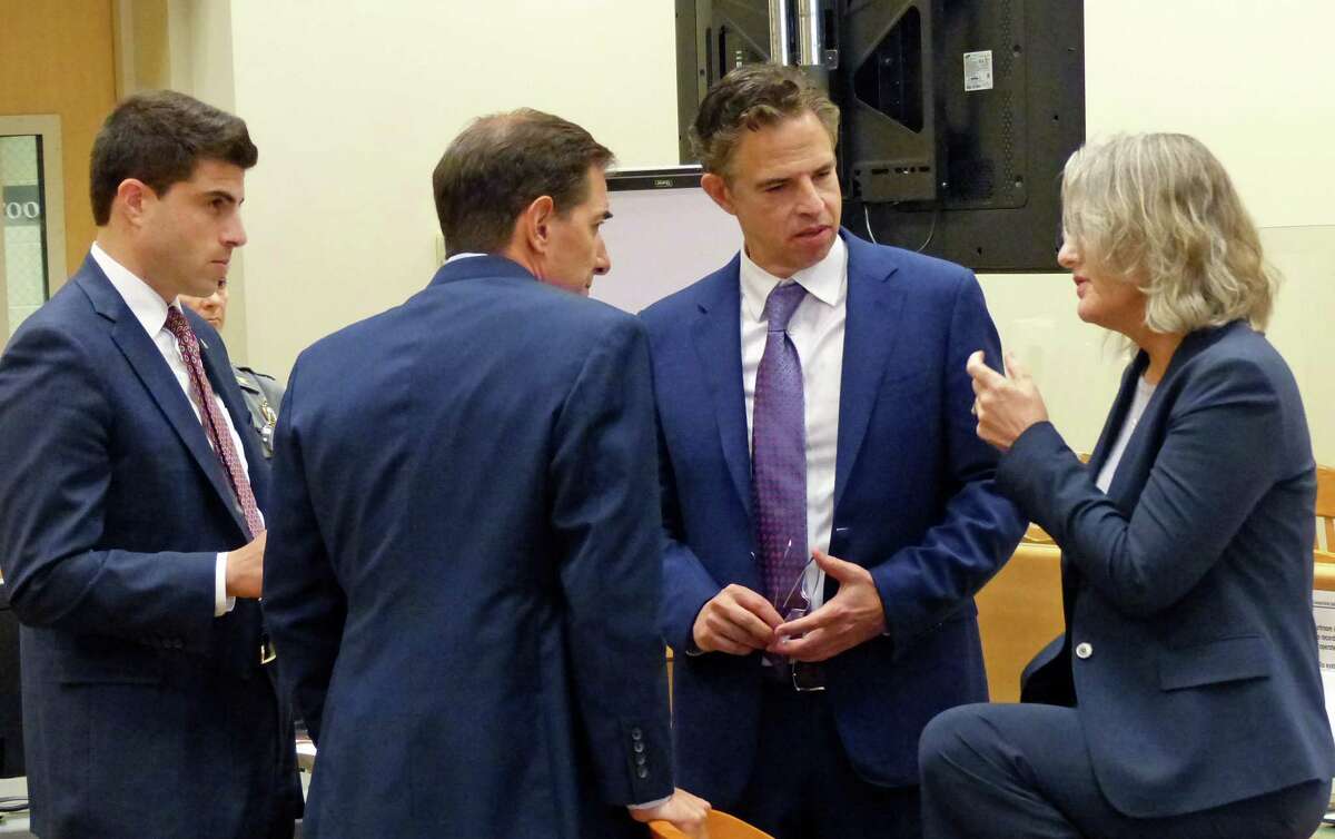 Sandy Hook family attorneys Matt Blumenthal, left, Chris Mattei, Josh Koskoff and Alinor Sterling, confer with each other on how to answer a question posed by the jury in the deliberation phase of the Alex Jones Sandy Hook defamation damages trial at Connecticut Superior Court in Waterbury, Conn. Friday, October 07, 2022.