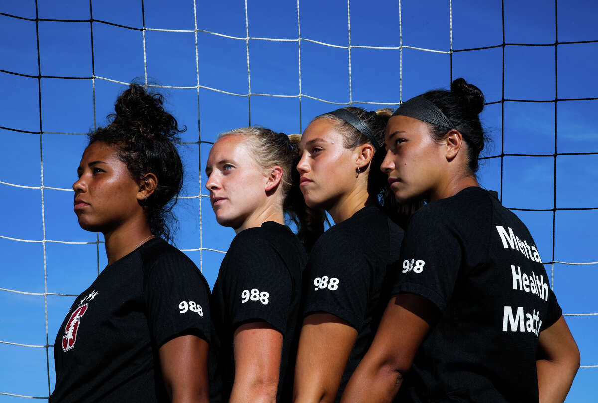 (From left to right): Senior defender Kennedy Wesley, 21, fifth year midfielder Sierra Enge, 22, senior defender Paige Rubinstein, 21, and senior midfielder Maya Doms, 21, pose for a portrait at Stanford University on Tuesday, September 27, 2022, in Stanford, Calif. The soccer teammates don warmup jerseys that say Mental Health Matters on the back and have the suicide hotline number, 988, on their sleeve. Their former teammate Katie Meyer, 22, was a goalie with the women?•s soccer team who committed suicide earlier this year.