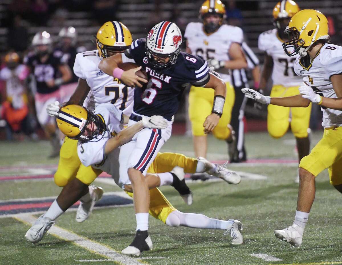 Foran receiver Juan LaBoy is tackled by East Haven's Garret Benson during the first half of their football game at Foran High School in Milford, Conn. on Friday, October 7, 2022.