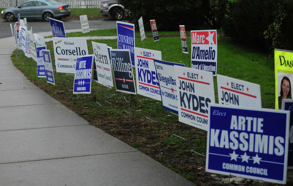 Campaign signs outside Nathan Hale Middle School during polling Tuesday, November 8, 2017, in Norwalk, Conn.