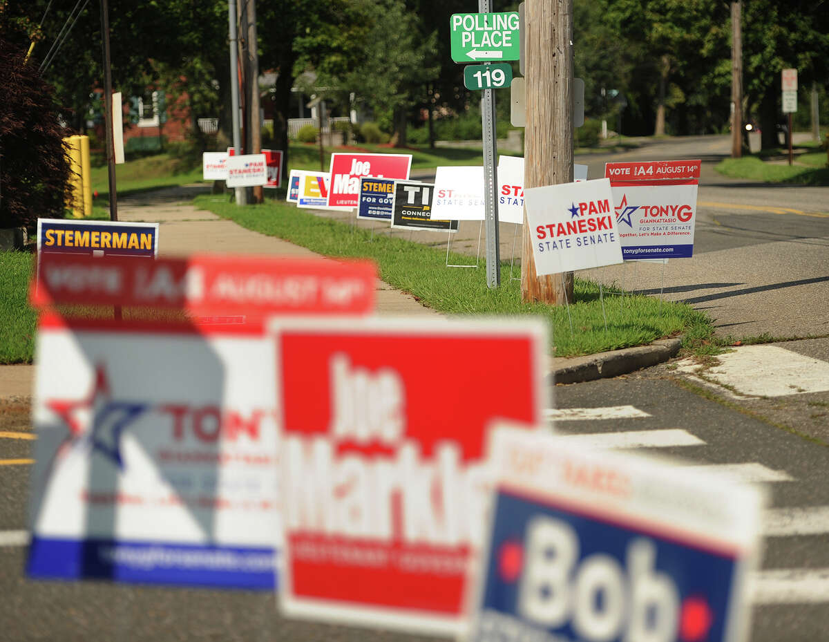 Campaign signs outside the polls at Orange Avenue School in Milford, Conn on Tuesday, August 14, 2018.