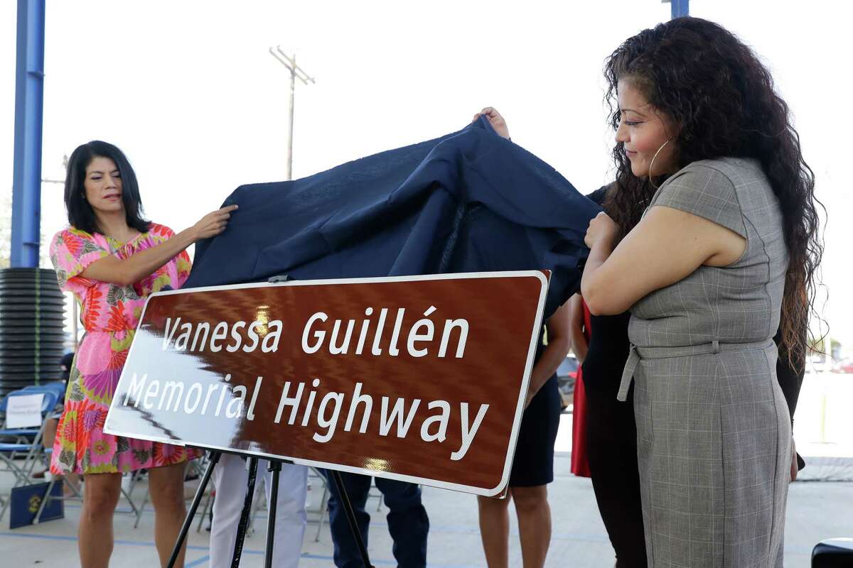 Standing with other family and dignitaries, Sen. Carol Alvarado, left, and Gloria Gullien, right, mother of Vanessa Gullien, unveil the new highway sign memorializing Vanessa Gullien during a ceremony held at the KIPP school grounds Saturday, Oct. 8, 2022 in Houston, TX.