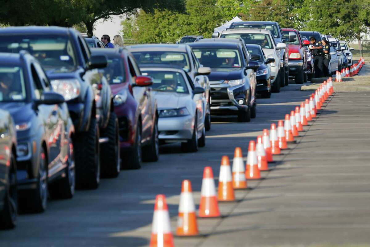 Some 300 cars, divided into lines based on how many guns they are tuning in, wait as they are processed before actually dropping of any weapons during the second gun buy back program, held at the Metro Westchase Park and Ride location Saturday, Oct. 8, 2022 in Houston, TX.