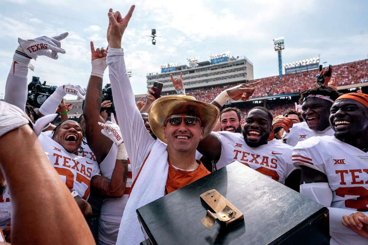 Texas head coach Steve Sarkisian celebrates with the golden hat after his team's 49-0 victory over Oklahoma in an NCAA college football game at the Cotton Bowl, Saturday, Oct. 8, 2022, in Dallas. (AP Photo/Jeffrey McWhorter)