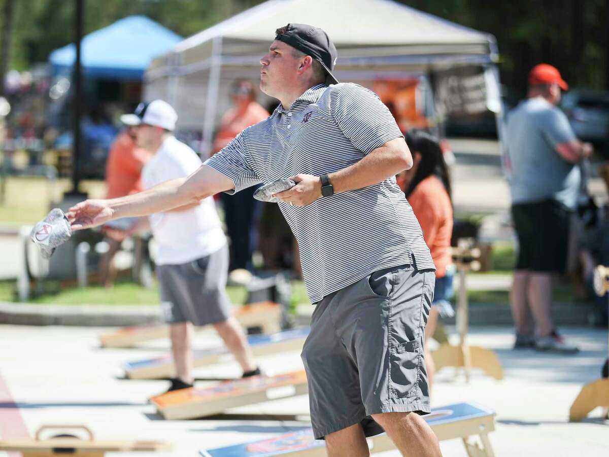 John Wayne McMann competes in The Montgomery County Choral Society’s annual cornhole fundraiser at Southern Star Brewery Co., Saturday, Oct. 8, 2022, in Conroe. The singing group, which celebrated its 50th season last year, raised $10,000 from the event last year.