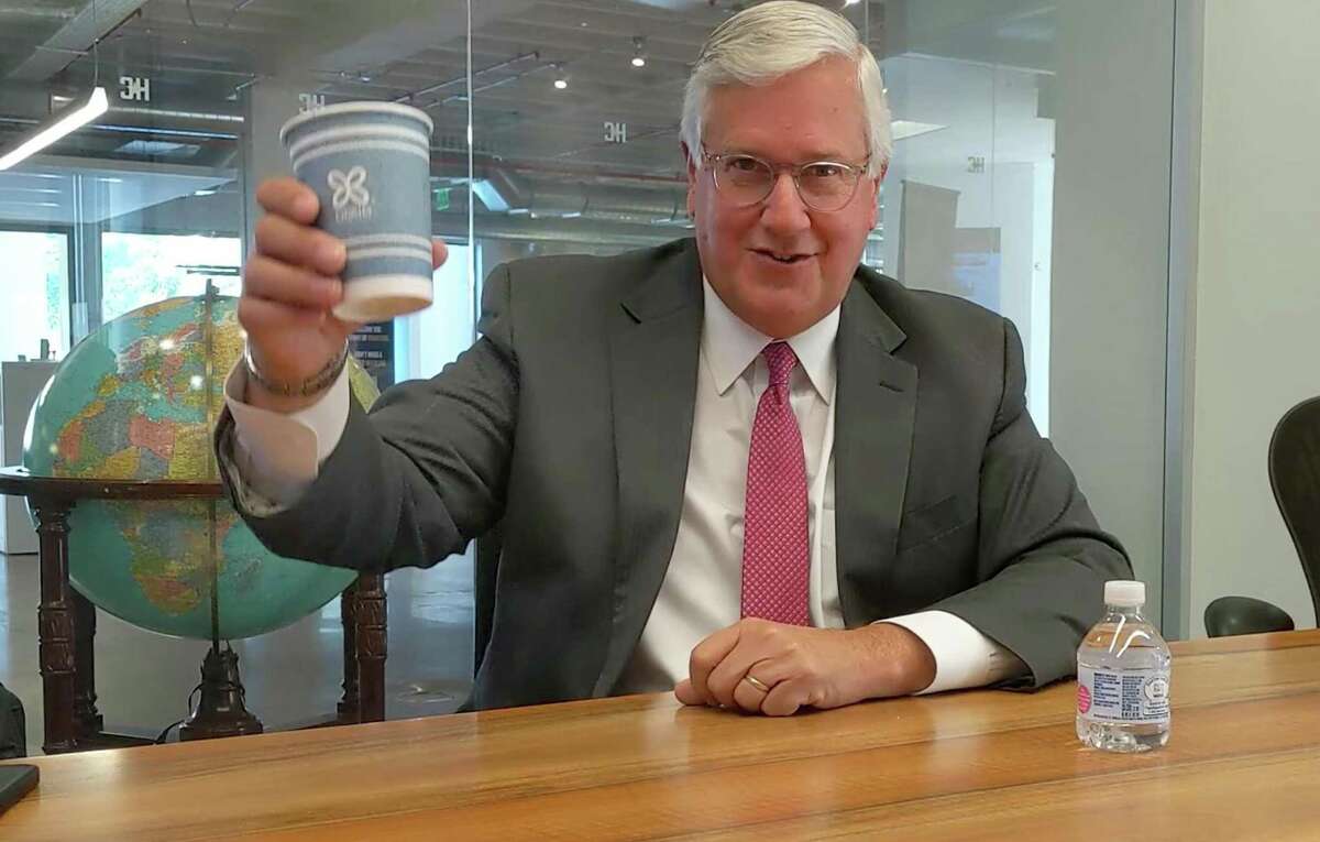 Mike Collier explains Texas' property tax system, using water bottles and cups as props.