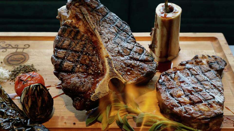 A meat board complete with flaming sage is shown at Doris Metropolitan, 2815 S. Shepherd, Wednesday, Dec. 6, 2017, in Houston.