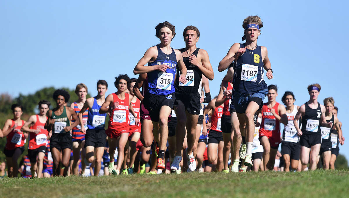 Runners, including Cole McCue (319) of Cumberland (RI), Owen Martin (1642) of Xavier, and Luke Davis (1187) of Simsbury at the start of the large school boys race during the Wickham Park Cross Country Invitational in Manchester on Saturday, Oct. 8, 2022.