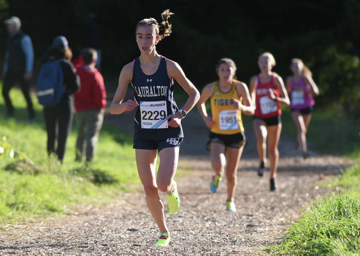 Lauralton Hall's Kelly Jones (2229) leads a group of runners along the trail during the medium school girls race at the Wickham Park Cross Country Invitational on Saturday, Oct. 8, 2022.