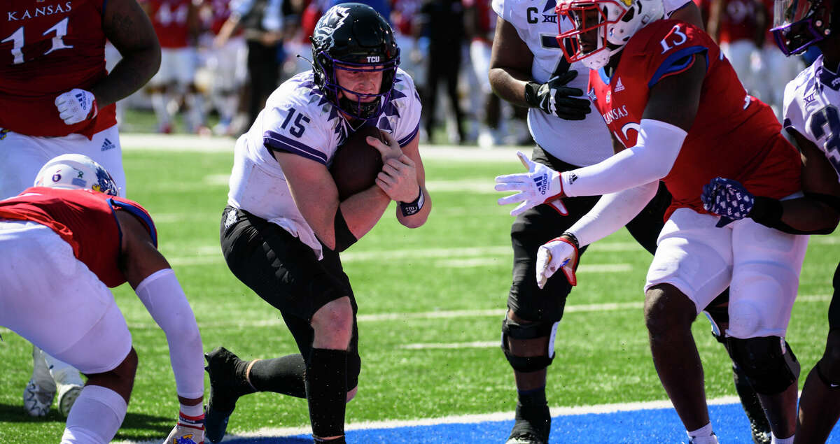 TCU quarterback Max Duggan (15) scores a touchdown against Kansas during the second half of an NCAA college football game Saturday, Oct. 8, 2022, in Lawrence, Kan. (AP Photo/Reed Hoffmann)