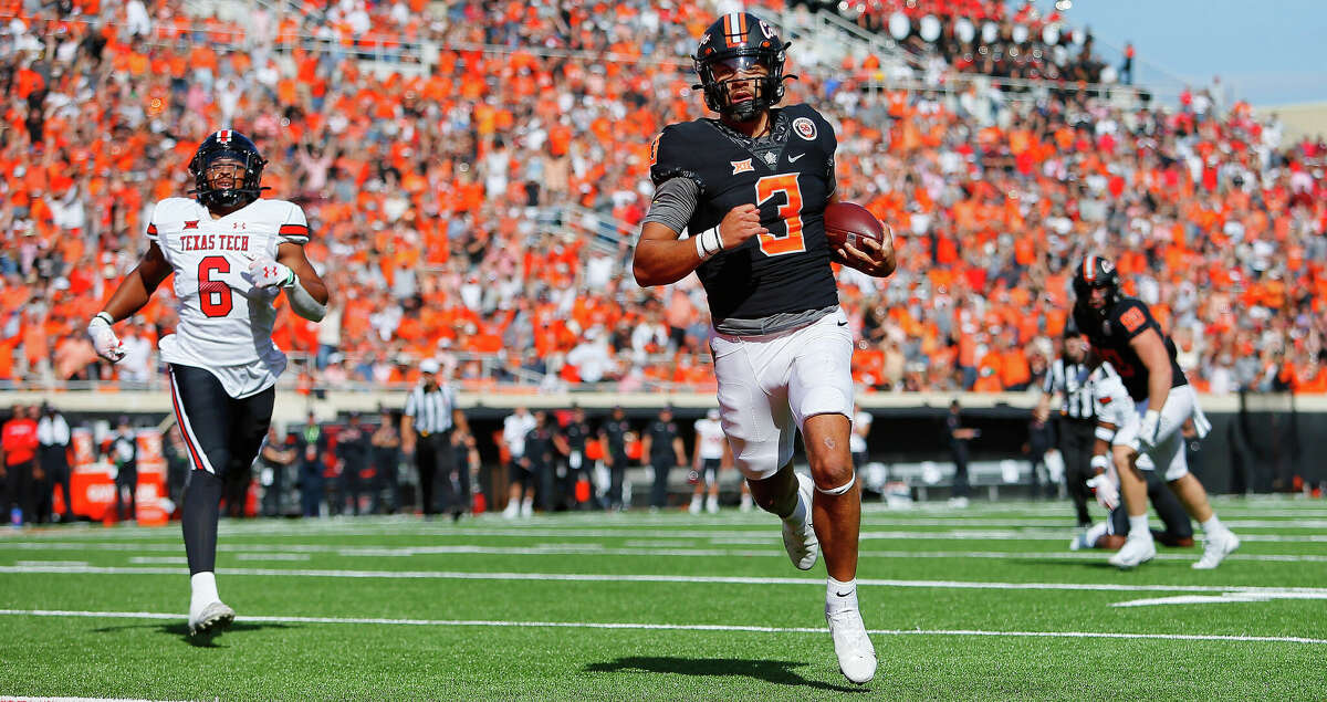 Quarterback Spencer Sanders #3 of the Oklahoma State Cowboys scores a touchdown on a 14-yard run in the first quarter against linebacker Kosi Eldridge #6 of the Texas Tech Red Raiders at Boone Pickens Stadium on October 8, 2022 in Stillwater, Oklahoma. (Photo by Brian Bahr/Getty Images)