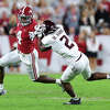 TUSCALOOSA, ALABAMA - OCTOBER 08: Jalen Milroe #4 of the Alabama Crimson Tide rushes away from Denver Harris #2 of the Texas A&M Aggies during the first half at Bryant-Denny Stadium on October 08, 2022 in Tuscaloosa, Alabama. (Photo by Kevin C. Cox/Getty Images)