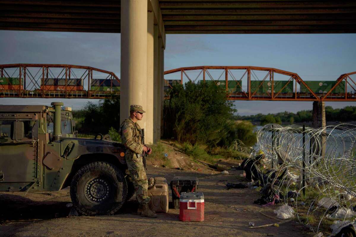 A member of the National Guard monitors the Rio Grande in Eagle Pass this spring. Officials with the Texas Military Department acknowledged that the payroll system they used for the mission has withheld too little in federal taxes from service members’ paychecks.