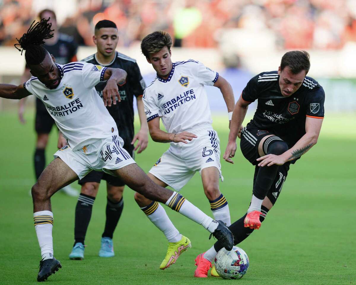 Houston Dynamo forward Corey Baird (11) battles with Los Angeles Galaxy players Raheem Edwards (44) and Riqui Puig (6) for the ball during the first half of a MLS match Sunday, Oct. 9, 2022, at PNC Stadium in Houston.