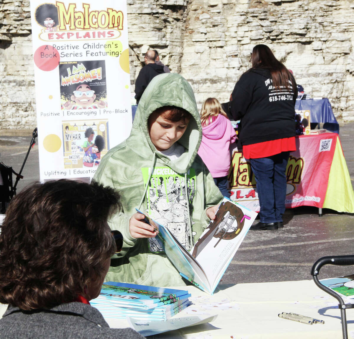 Anthony Lefler, 11, of South Roxana, looks over a book on Alton history the Hayner Library Local Author Book Fair Saturday at the main library on State Street. The event featured approximately 30 local authors from a variety of genres, as well as showcasing some of the librarie's services.
