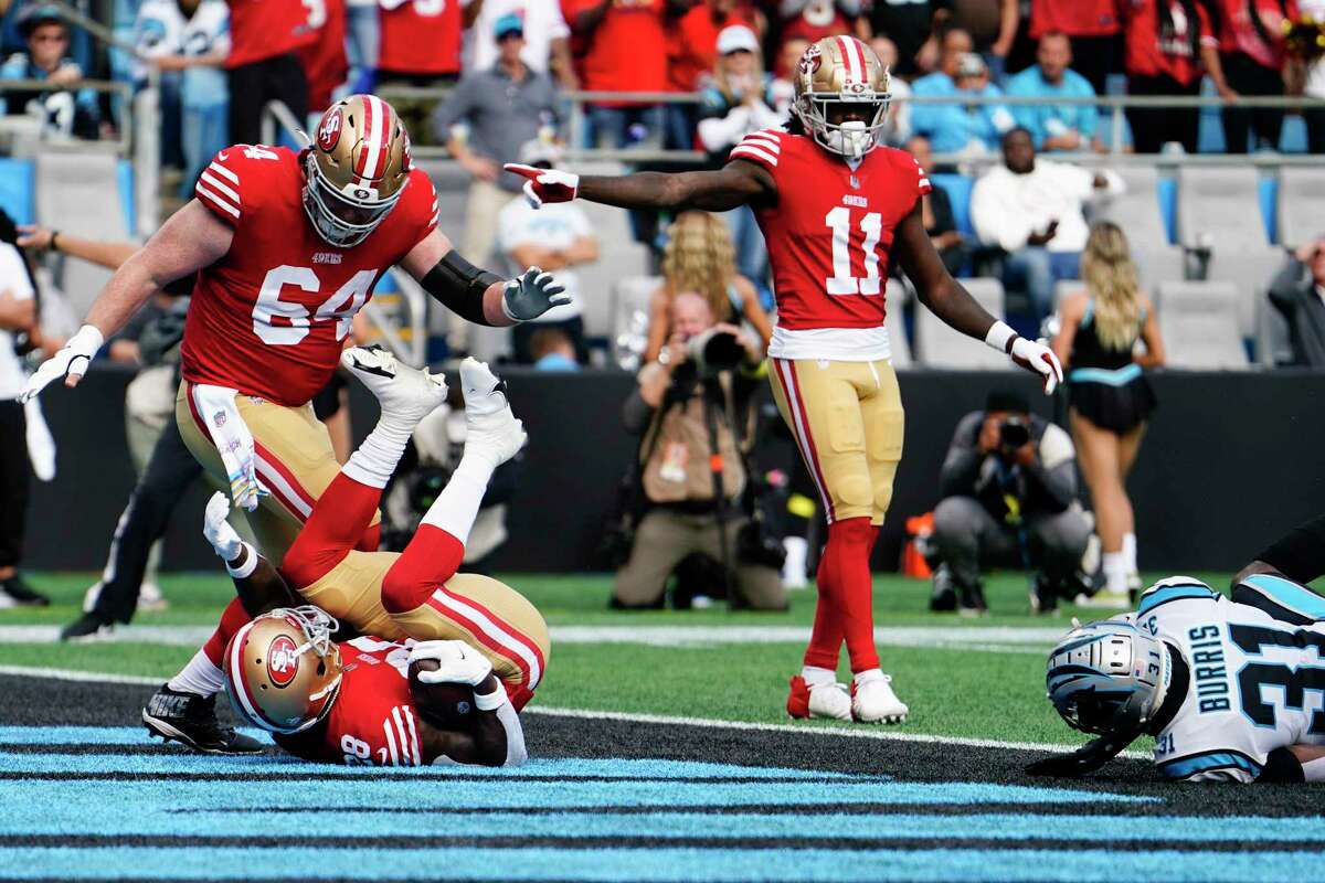 San Francisco 49ers running back Tevin Coleman scores past Carolina Panthers safety Juston Burris during the first half an NFL football game on Sunday, Oct. 9, 2022, in Charlotte, N.C. (AP Photo/Jacob Kupferman)