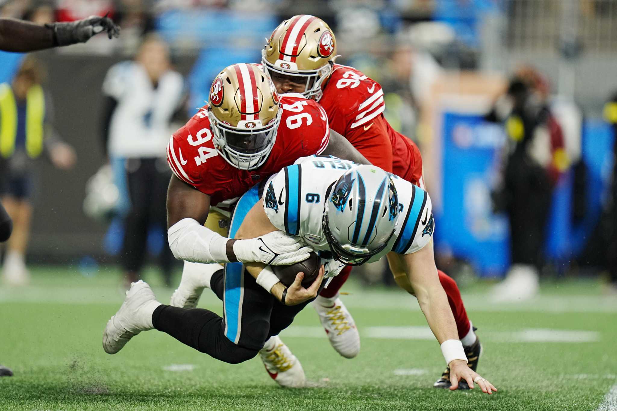 San Francisco 49ers defensive end Charles Omenihu poses with San