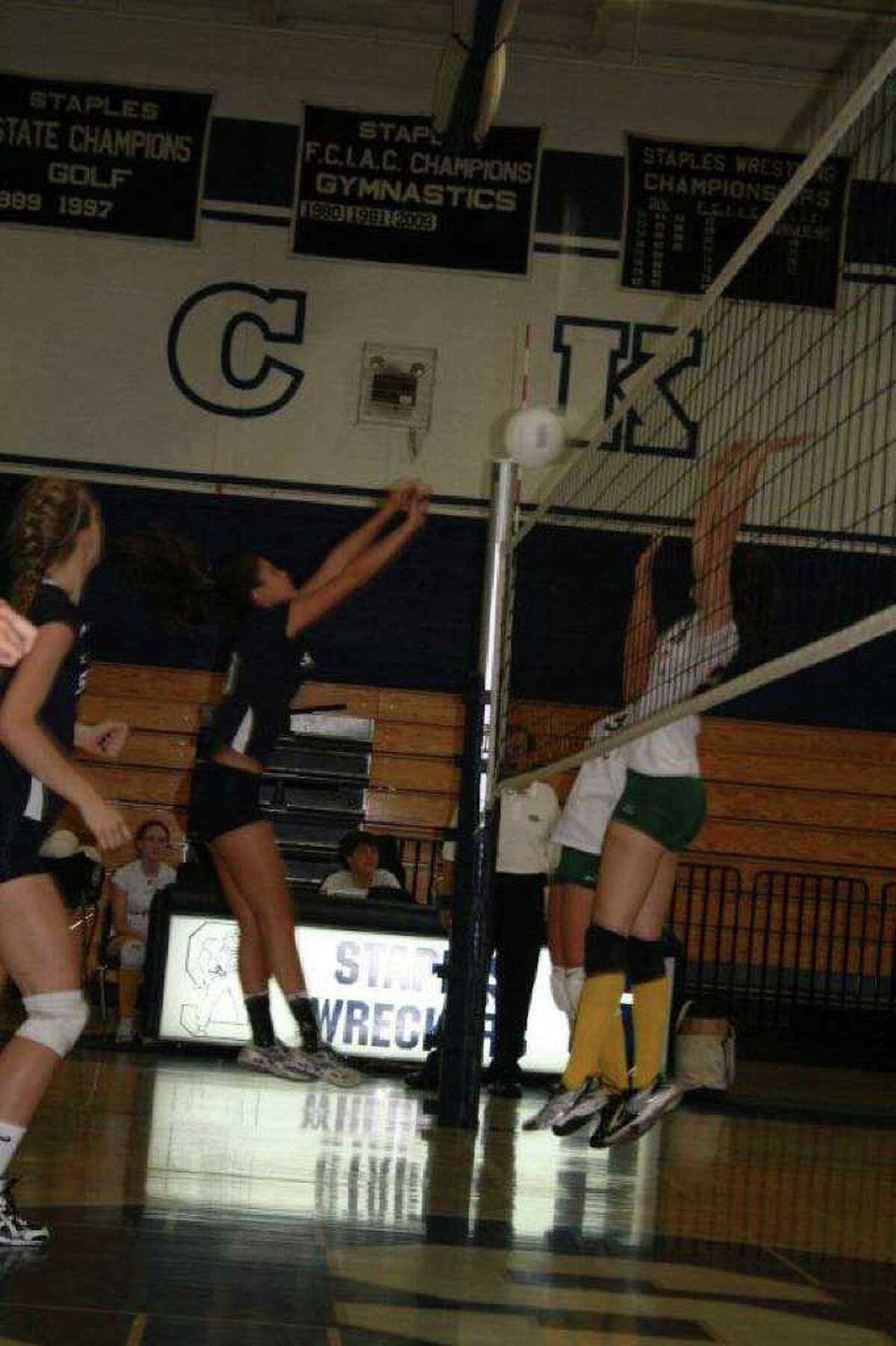 Staples senior tri-captain Alex Masiello delivers one of her 11 kills on Wednesday in a 3-0 home victory over Trinity Catholic.