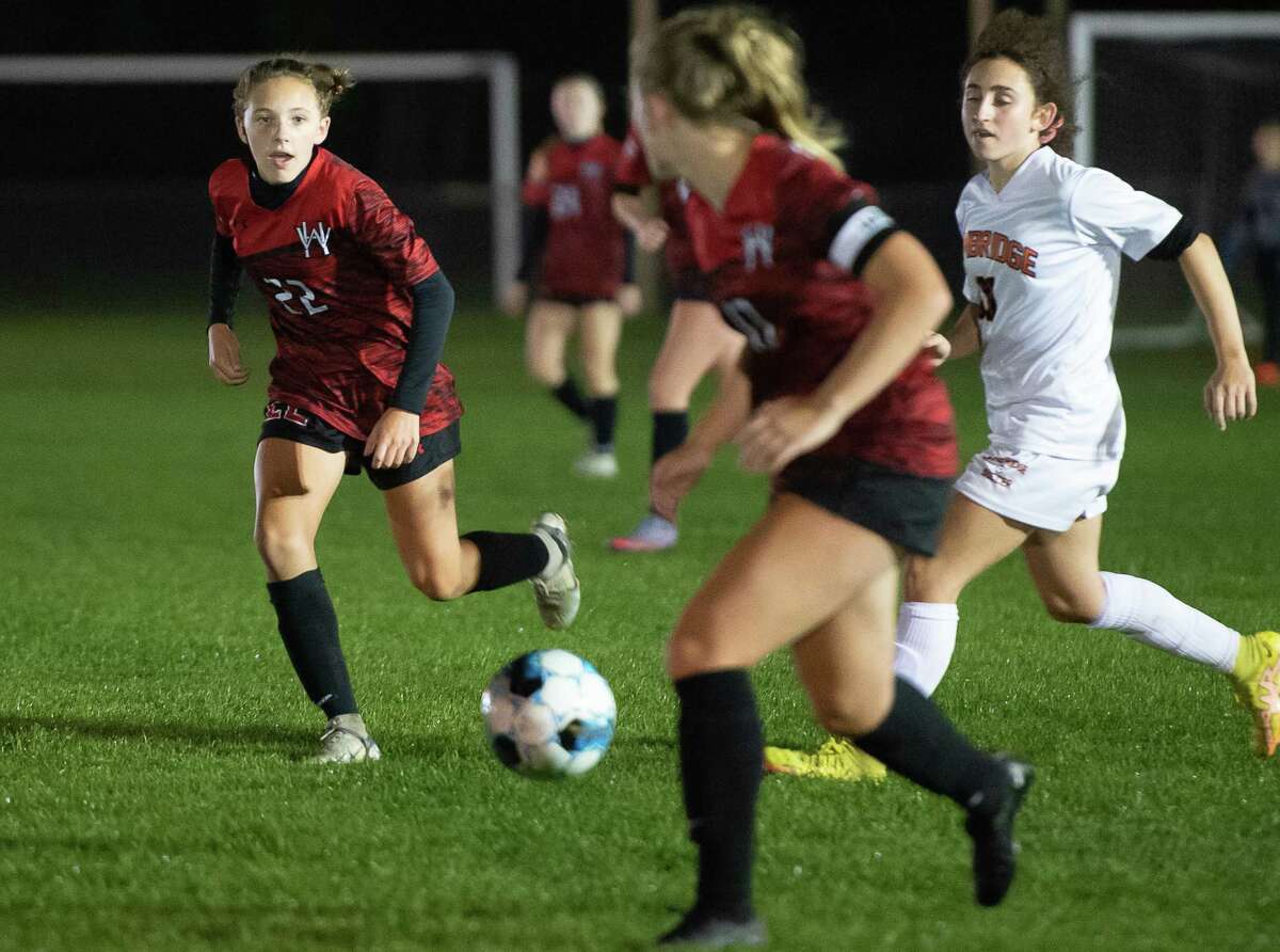 Waterford-Halfmoon's Payton Galuski, left, receives a pass from her sister, Addyson Galuski, during a game against Cambridge this season. Payton Galuski had 39 goals and 21 assists, earning Athlete of the Year honors as a seventh grader.